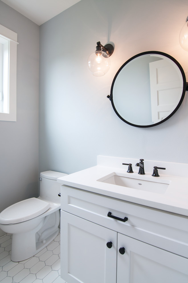 Photo of a small arts and crafts 3/4 bathroom in Other with shaker cabinets, white cabinets, a two-piece toilet, blue walls, ceramic floors, an undermount sink, engineered quartz benchtops and white floor.