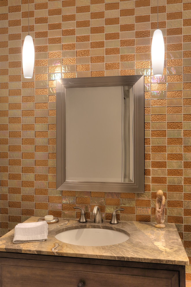 Mid-sized contemporary powder room in Jacksonville with furniture-like cabinets, distressed cabinets, marble benchtops, glass tile, brown tile, orange tile, orange walls and an undermount sink.