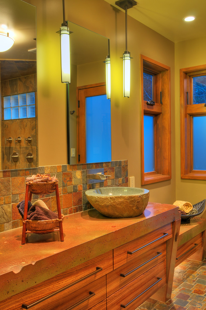 Design ideas for a mid-sized country master bathroom in Seattle with a vessel sink, flat-panel cabinets, medium wood cabinets, concrete benchtops, an open shower, a two-piece toilet, multi-coloured tile, stone tile, green walls and slate floors.