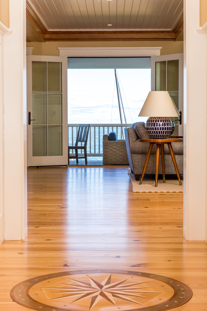 Inspiration for a mid-sized beach style hallway in Boston with beige walls, light hardwood floors and beige floor.