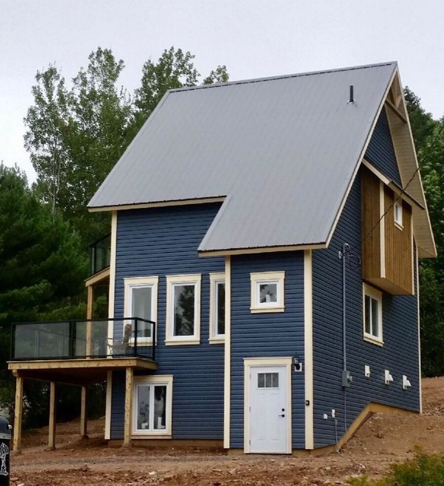 Small blue split-level mixed siding gable roof idea with a metal roof