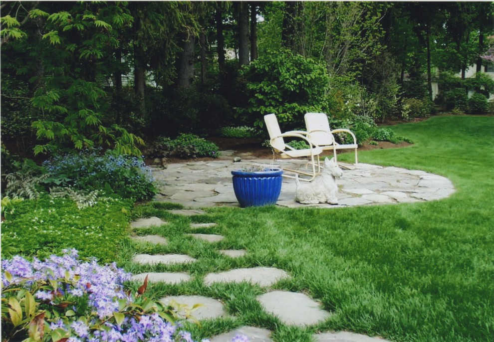 Photo of a mid-sized traditional backyard partial sun garden in Boston with natural stone pavers and a garden path.