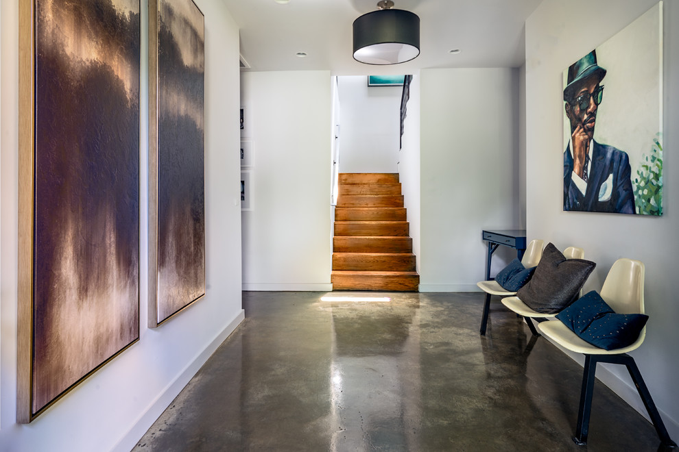 Inspiration for a contemporary hallway in Nashville with white walls, concrete floors and grey floor.