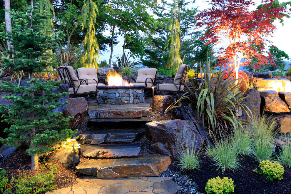 Inspiration for a large contemporary backyard patio in Seattle with natural stone pavers, a fire feature and no cover.