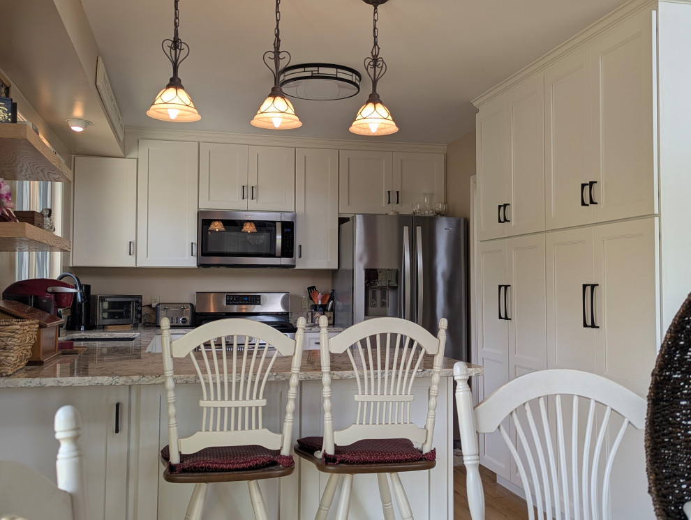 Eat-in kitchen - small transitional u-shaped eat-in kitchen idea with flat-panel cabinets