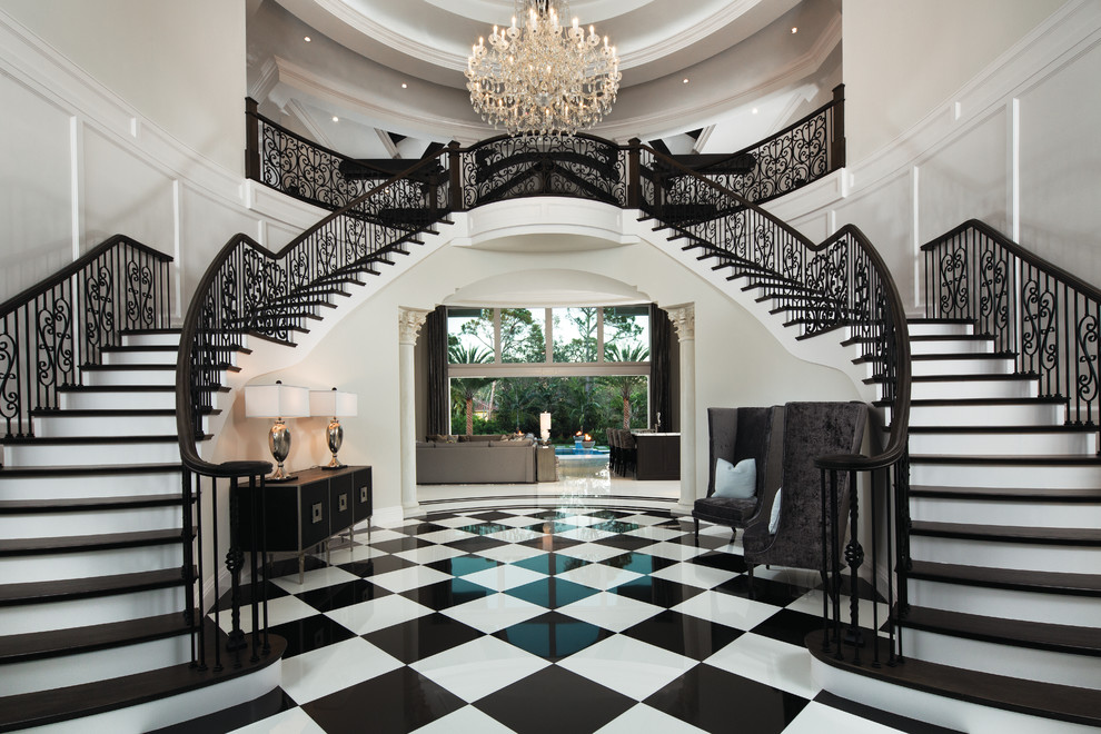 Traditional foyer in Miami with marble floors, multi-coloured floor and white walls.