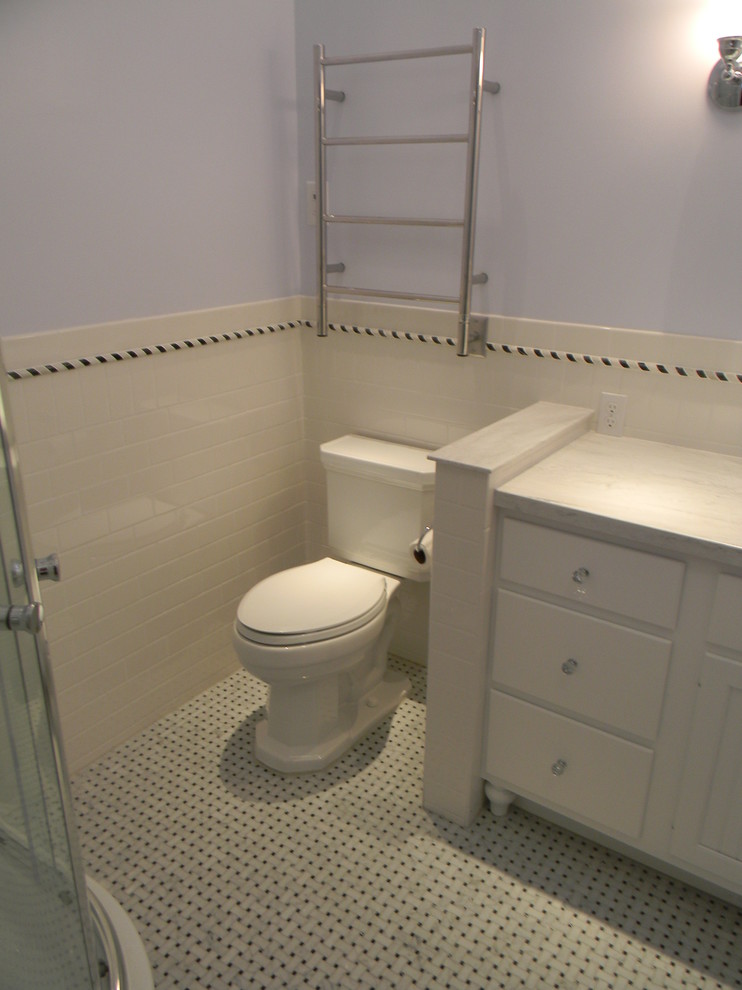 Photo of a mid-sized traditional master bathroom in Providence with shaker cabinets, white cabinets, marble benchtops, white tile, ceramic tile, a corner shower, a two-piece toilet, blue walls and ceramic floors.