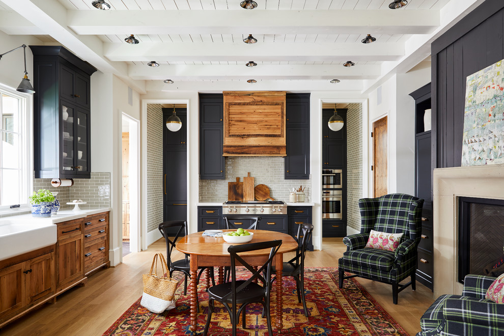 Large farmhouse light wood floor dining room photo in Charlotte with a farmhouse sink, beaded inset cabinets, marble countertops, gray backsplash, subway tile backsplash, no island, white walls and a standard fireplace