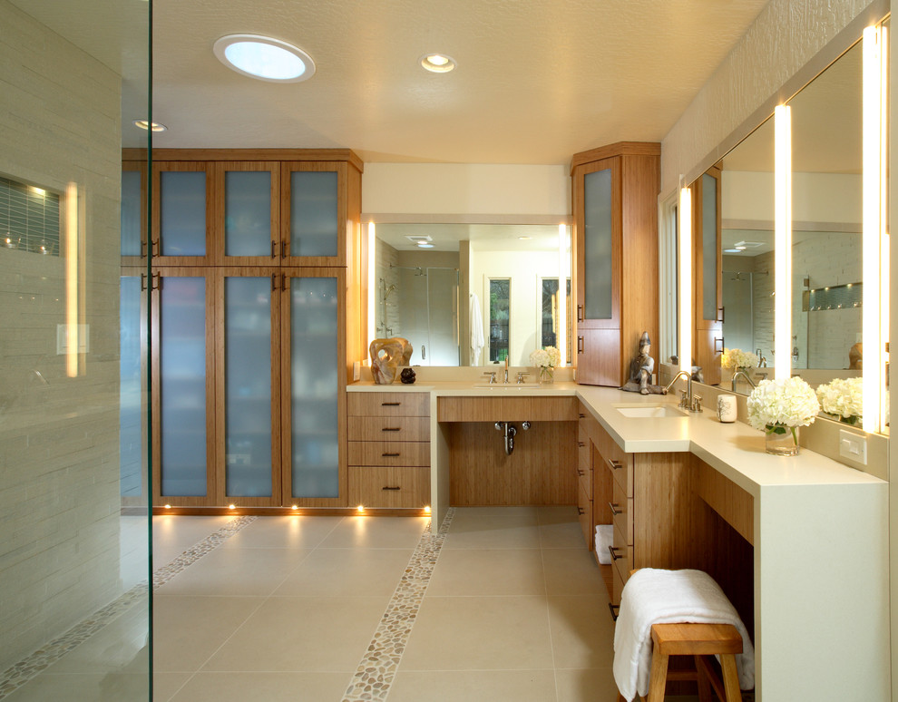 Design ideas for a large contemporary master bathroom in San Francisco with an undermount sink, flat-panel cabinets, medium wood cabinets, beige tile, pebble tile floors, a corner shower, stone tile and beige walls.