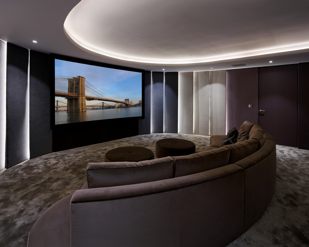 This is an example of a contemporary enclosed home theatre in Los Angeles with carpet and a projector screen.