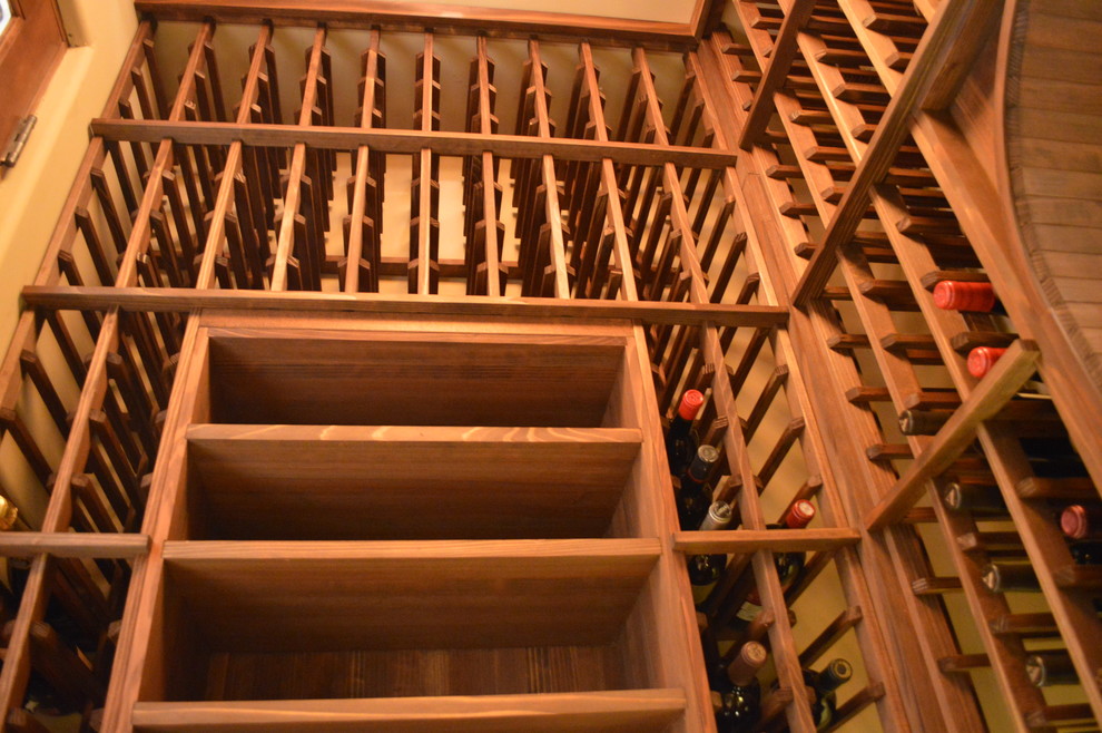 Design ideas for a mid-sized country wine cellar in Orange County with display racks.