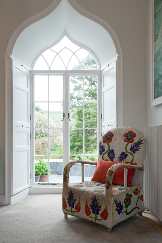 Eclectic bedroom in Devon with white walls, carpet and grey floor.