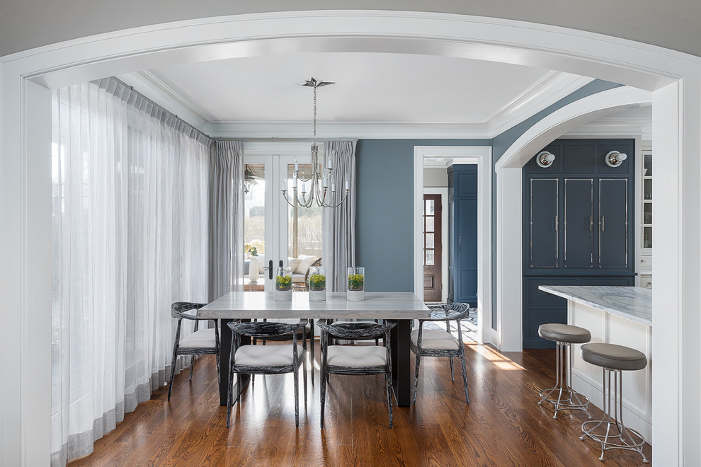 Example of a large transitional medium tone wood floor and brown floor dining room design in Chicago with a farmhouse sink, beaded inset cabinets, blue cabinets, marble countertops, white backsplash, ceramic backsplash, stainless steel appliances, two islands and yellow countertops