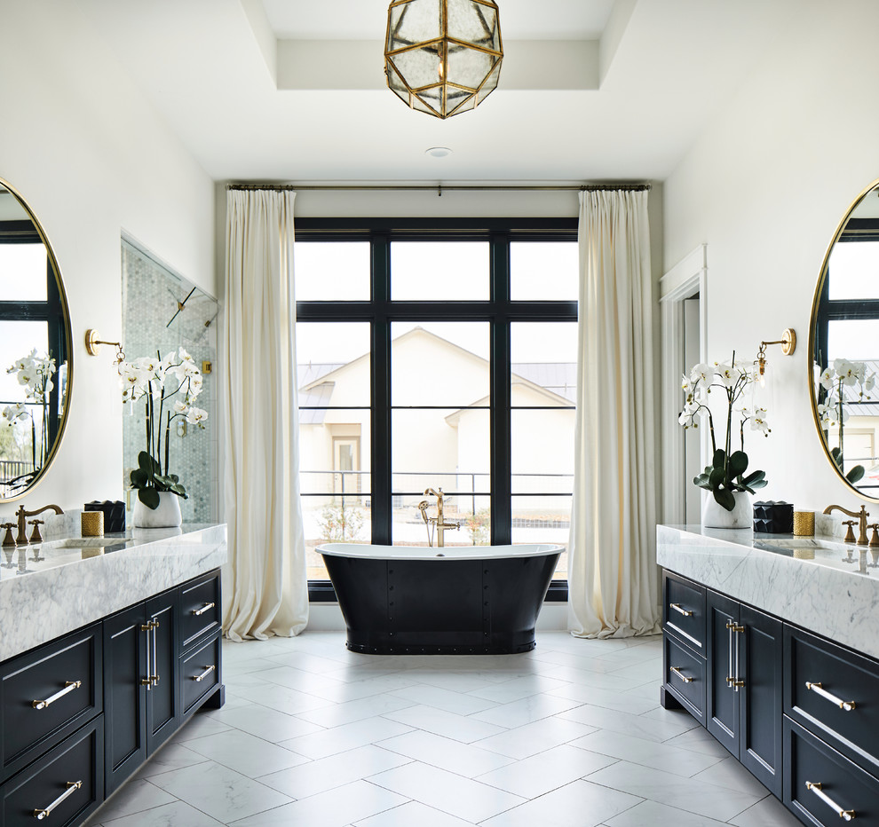 Inspiration for a transitional master bathroom in Other with recessed-panel cabinets, blue cabinets, a freestanding tub, white walls, an integrated sink, white floor and white benchtops.