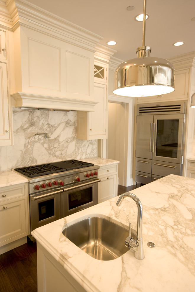 Design ideas for a large transitional u-shaped eat-in kitchen in Chicago with an undermount sink, white cabinets, marble benchtops, white splashback, stone slab splashback, stainless steel appliances, medium hardwood floors, with island and recessed-panel cabinets.