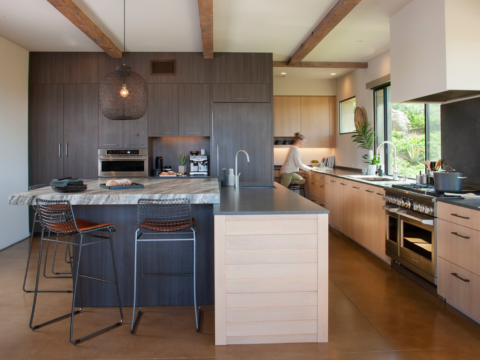 Photo of a large contemporary kitchen in San Diego with an undermount sink, flat-panel cabinets, light wood cabinets, quartz benchtops, panelled appliances, concrete floors, with island, grey floor and multi-coloured benchtop.