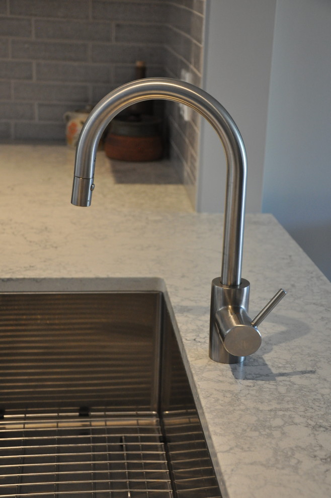 Small transitional u-shaped vinyl floor and beige floor eat-in kitchen photo in Vancouver with a single-bowl sink, shaker cabinets, white cabinets, quartz countertops, gray backsplash, ceramic backsplash, stainless steel appliances, no island and gray countertops