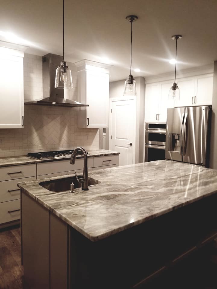 Example of a transitional kitchen design with flat-panel cabinets, white cabinets and an island