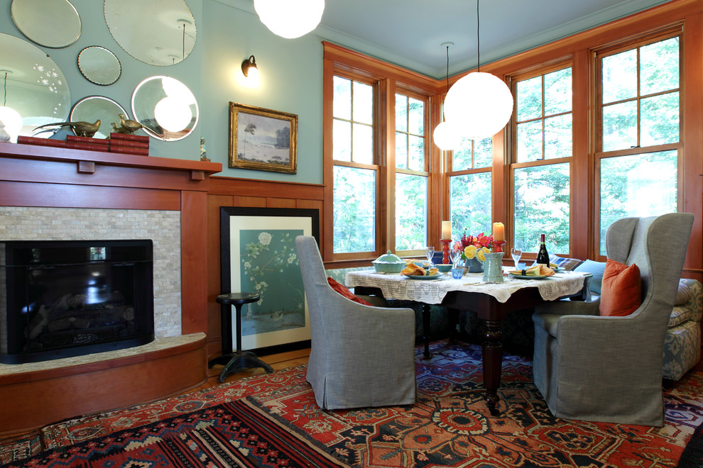 This is an example of a transitional dining room in San Francisco with a tile fireplace surround.