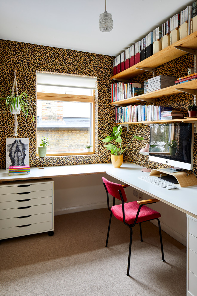 This is an example of a midcentury study room in London with multi-coloured walls, carpet, no fireplace, a built-in desk and beige floor.