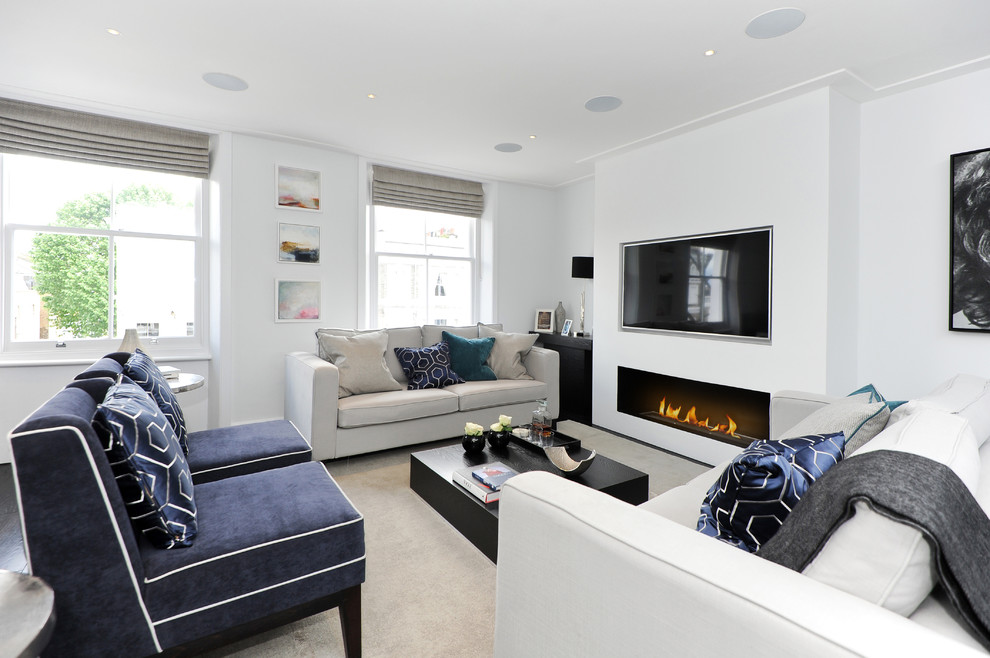 Transitional living room in London with white walls and a ribbon fireplace.