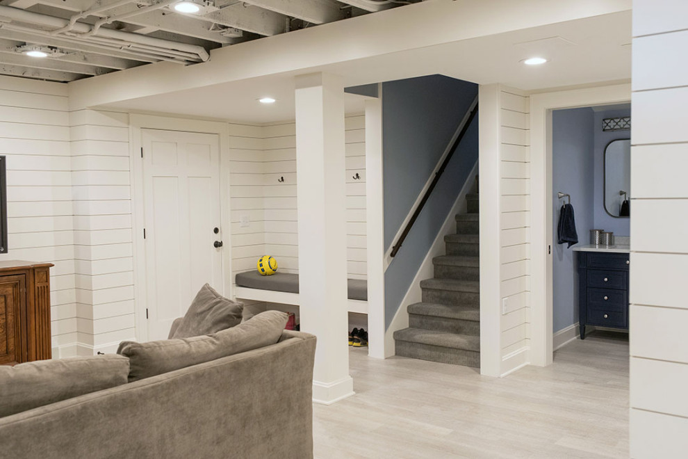Large transitional fully buried basement in Other with white walls, vinyl floors, beige floor and planked wall panelling.
