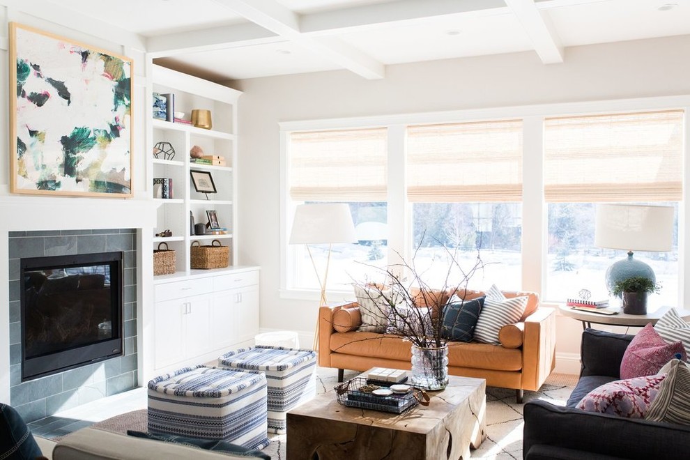 This is an example of a mid-sized beach style open concept living room in Salt Lake City with white walls, light hardwood floors, a standard fireplace and a built-in media wall.