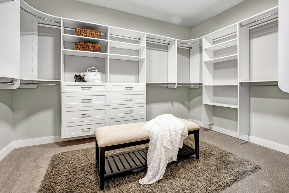 Design ideas for an arts and crafts gender-neutral walk-in wardrobe in Seattle with recessed-panel cabinets, white cabinets and carpet.