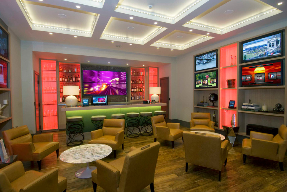 Large trendy enclosed medium tone wood floor game room photo in Houston with white walls, no fireplace and a media wall