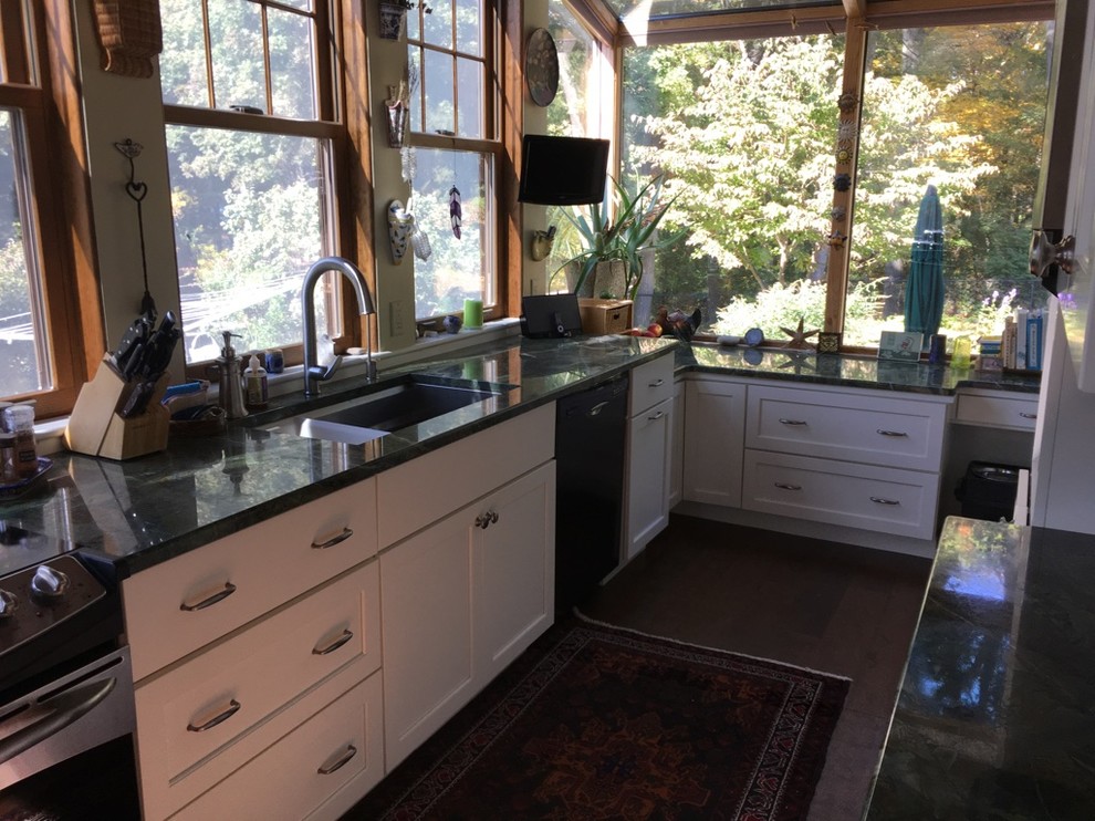 Example of a transitional u-shaped dark wood floor kitchen design in Boston with an undermount sink, shaker cabinets, white cabinets, granite countertops and stainless steel appliances