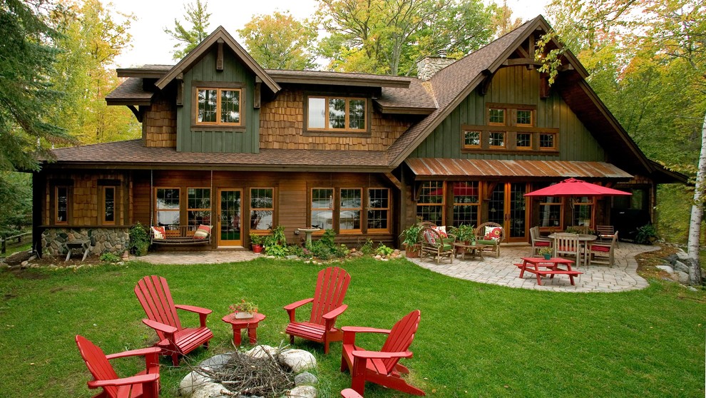 This is an example of a country two-storey green exterior in Minneapolis with wood siding.