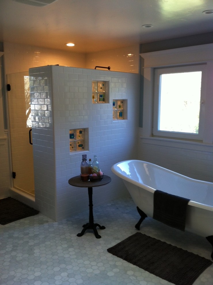 This is an example of a mid-sized transitional bathroom in Sacramento with a freestanding tub, a corner shower, white tile, subway tile, white walls and porcelain floors.