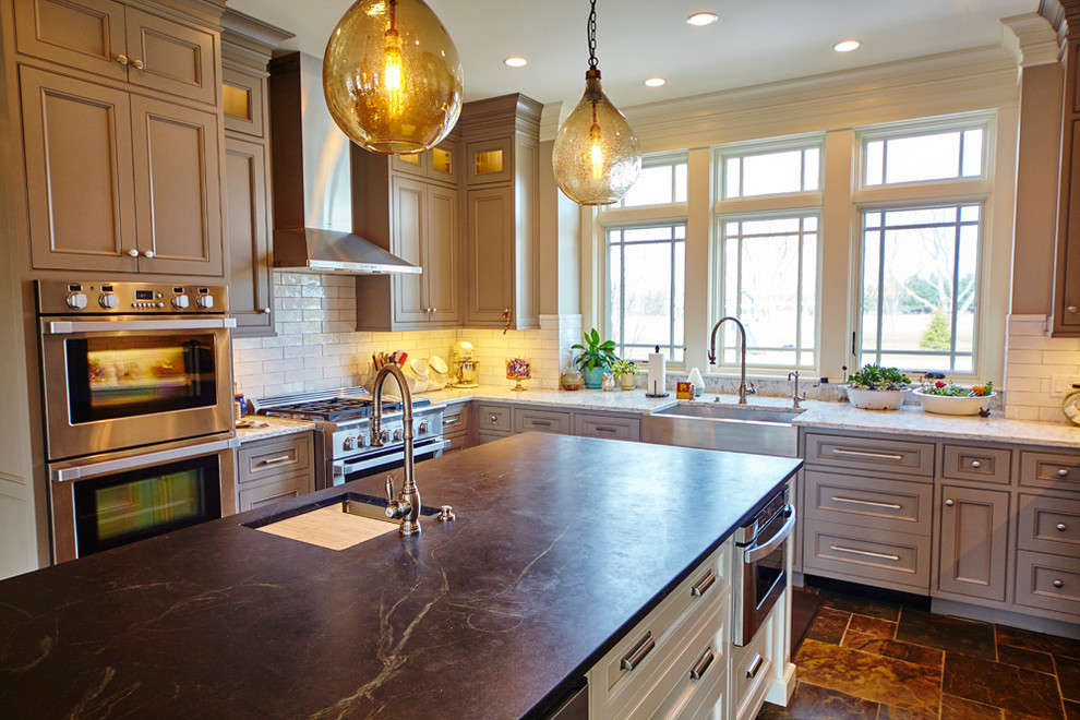 Eat-in kitchen - mid-sized transitional u-shaped eat-in kitchen idea with raised-panel cabinets and an island