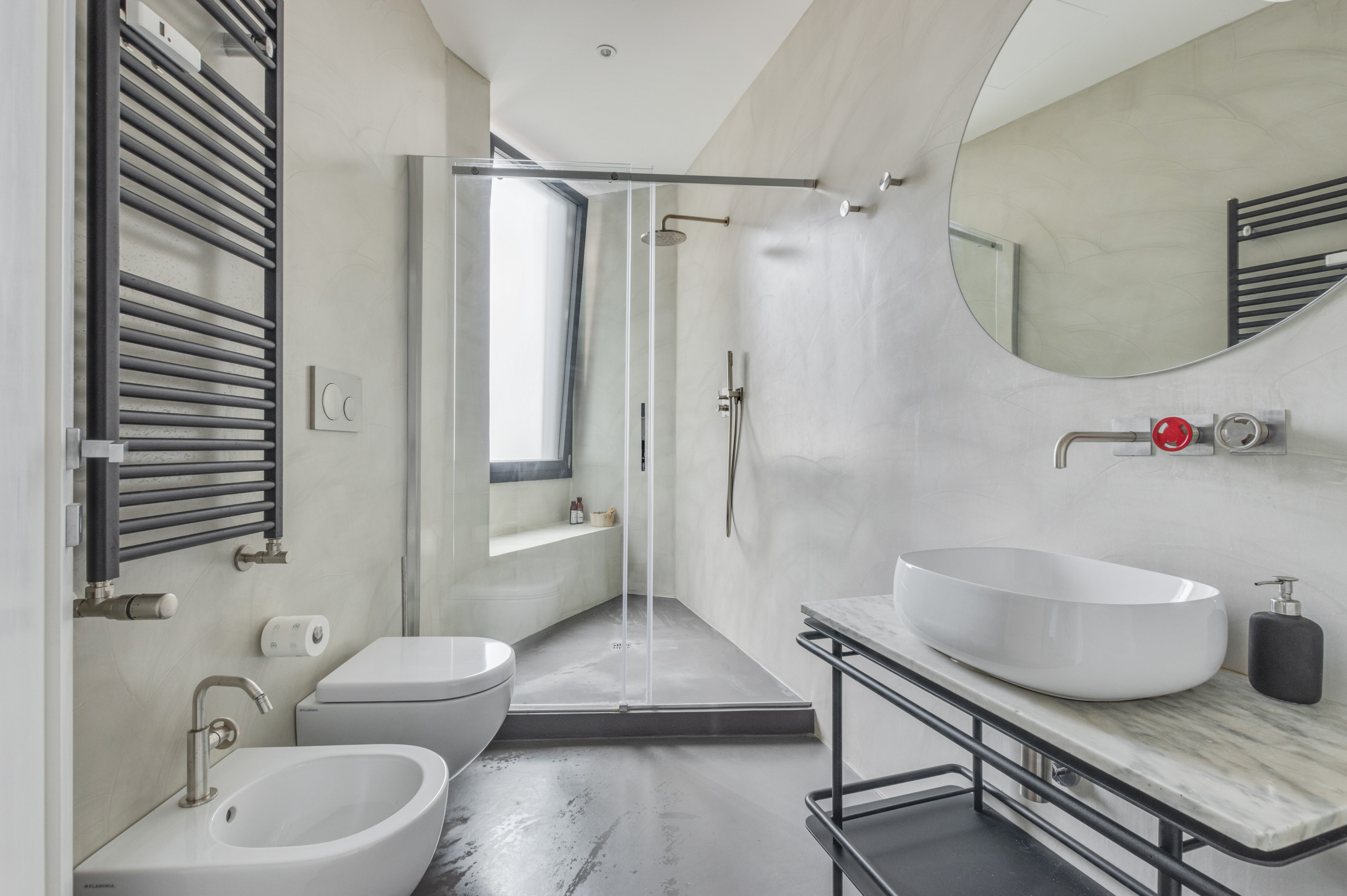 Huge urban 3/4 gray floor and single-sink sliding shower door photo in Rome with open cabinets, gray cabinets, a wall-mount toilet, gray walls, a vessel sink, marble countertops and a freestanding van