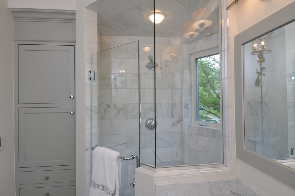 Photo of a mid-sized traditional master bathroom in Chicago with shaker cabinets, grey cabinets, a corner shower, a two-piece toilet, gray tile, stone tile, white walls, ceramic floors and marble benchtops.