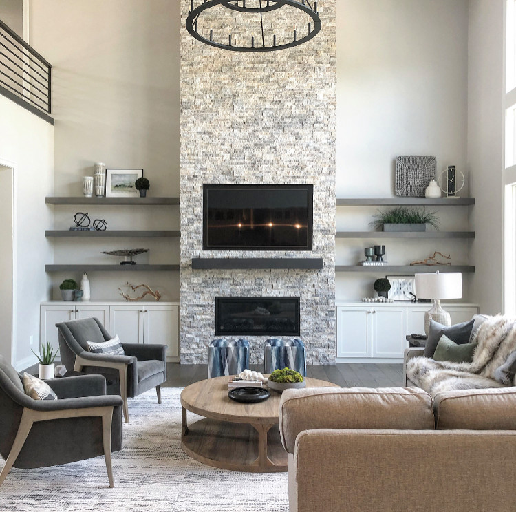 Inspiration for a large transitional loft-style dark wood floor, gray floor and exposed beam living room remodel in Other with gray walls, a standard fireplace and a stacked stone fireplace
