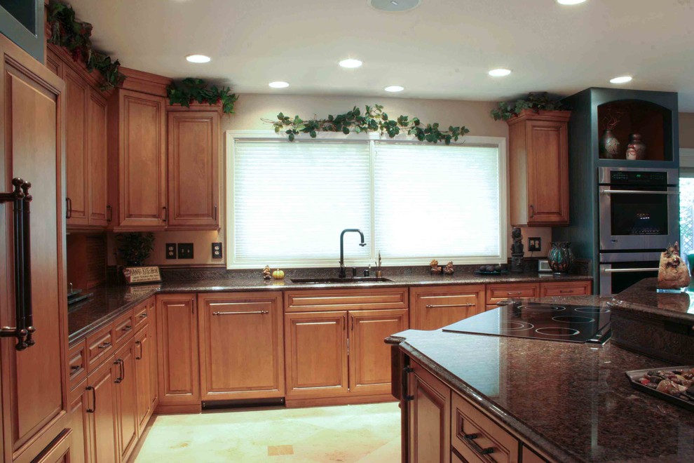Large transitional l-shaped ceramic tile eat-in kitchen photo with an undermount sink, medium tone wood cabinets, granite countertops, beige backsplash, ceramic backsplash, stainless steel appliances and an island