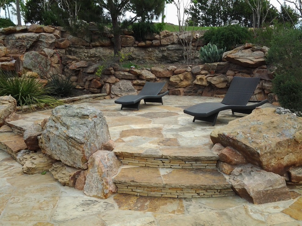 This is an example of a mediterranean patio in Houston with a fire feature.