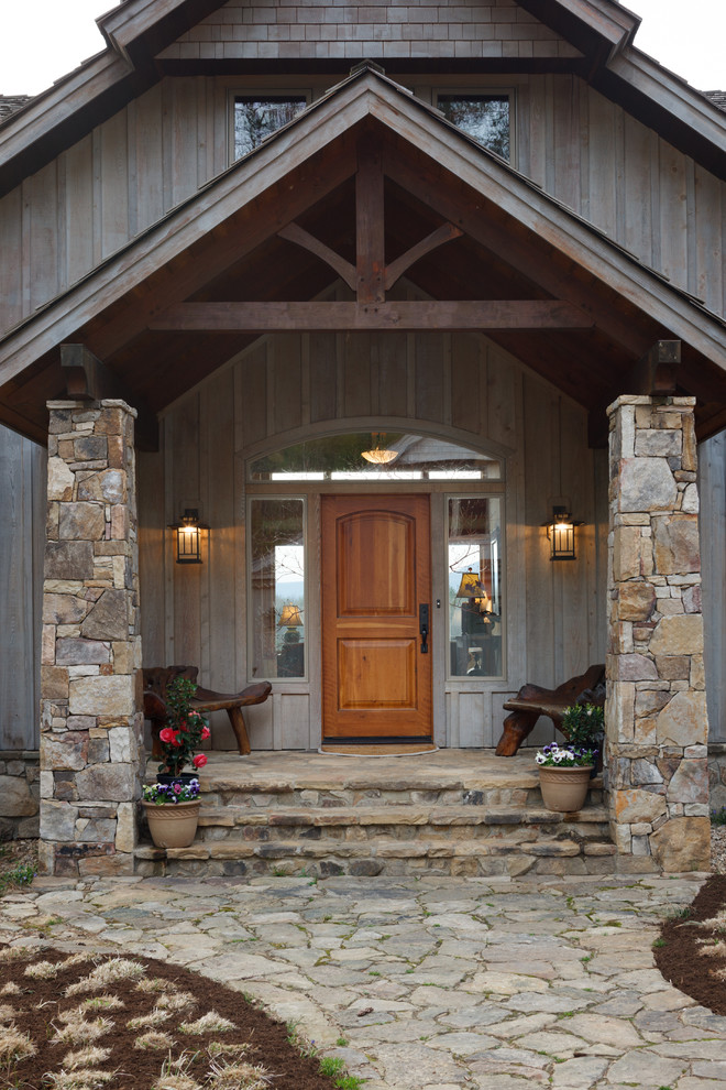 This is an example of a country front door in Richmond with a single front door and a medium wood front door.