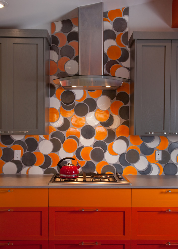 This is an example of a mid-sized modern galley eat-in kitchen in Other with an undermount sink, shaker cabinets, orange cabinets, quartz benchtops, orange splashback, ceramic splashback, stainless steel appliances, porcelain floors and a peninsula.