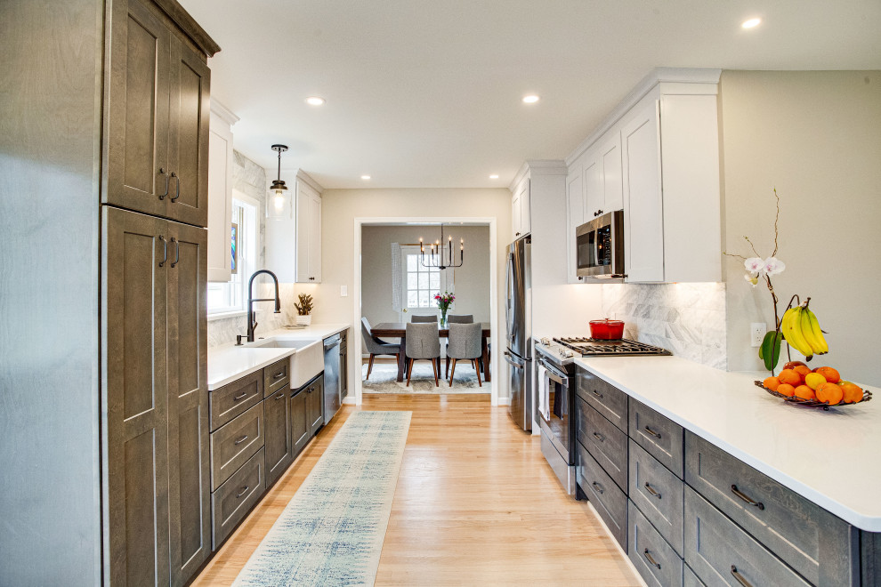 Inspiration for a small transitional single-wall kitchen remodel in DC Metro with a farmhouse sink, quartz countertops, stainless steel appliances and a peninsula