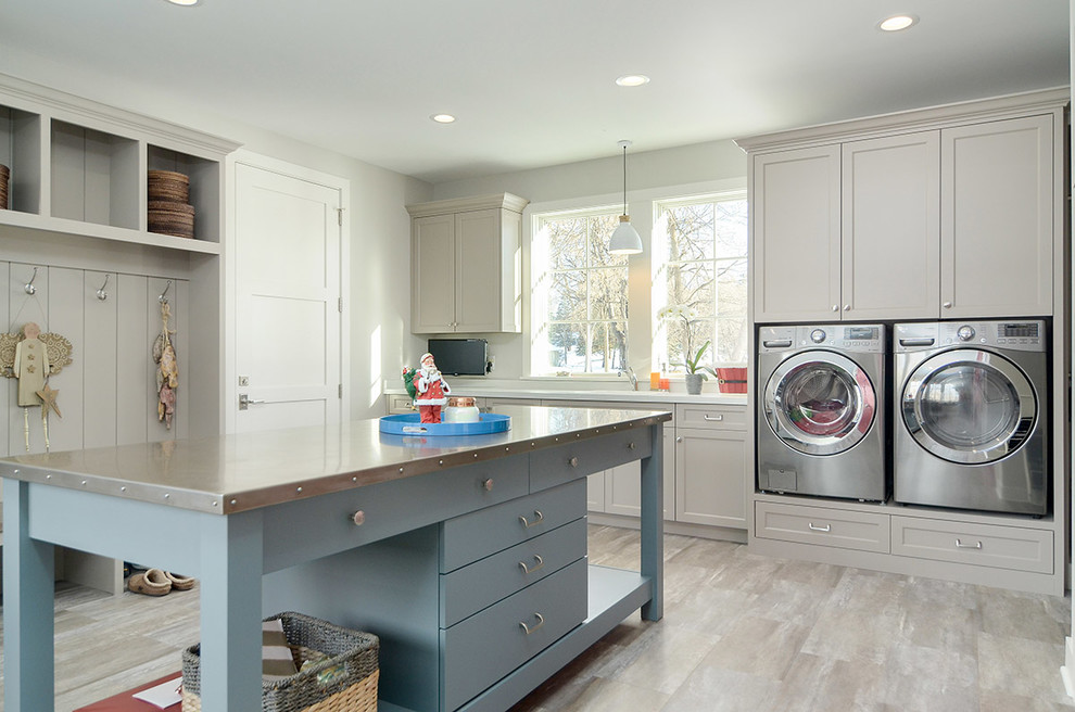 Large beach style utility room in Minneapolis with quartz benchtops, grey walls, laminate floors, a side-by-side washer and dryer, shaker cabinets, grey cabinets, grey floor and white benchtop.