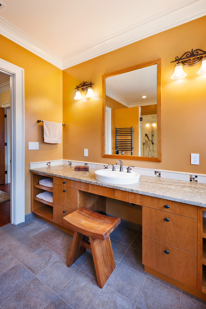 This is an example of a traditional bathroom in Seattle with a vessel sink, flat-panel cabinets, medium wood cabinets, granite benchtops, white tile, ceramic tile and yellow walls.
