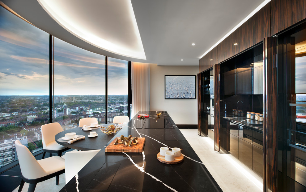 This is an example of a large contemporary single-wall separate kitchen in London with an integrated sink, recessed-panel cabinets, dark wood cabinets, marble benchtops, black splashback, marble splashback, stainless steel appliances, marble floors, with island, white floor and black benchtop.
