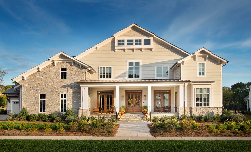This is an example of a large country two-storey exterior in Nashville with stone veneer.