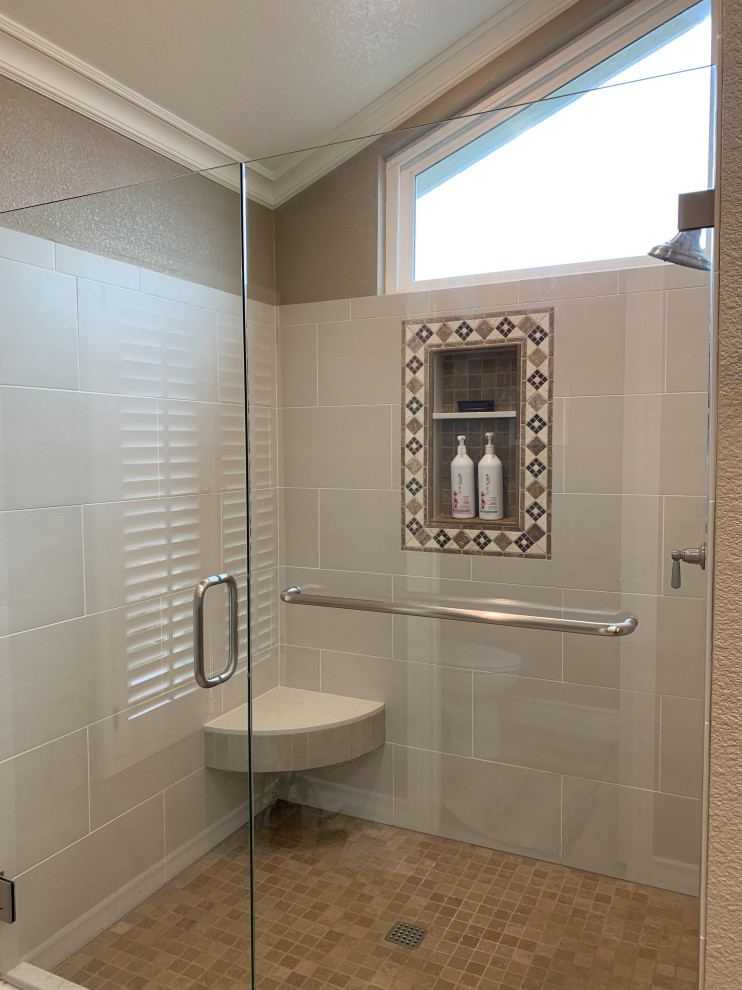 This is an example of a large classic ensuite bathroom with recessed-panel cabinets, brown cabinets, a built-in bath, an alcove shower, a one-piece toilet, grey tiles, porcelain tiles, beige walls, porcelain flooring, a submerged sink, engineered stone worktops, grey floors, a hinged door, multi-coloured worktops, a wall niche, double sinks, a built in vanity unit and a vaulted ceiling.