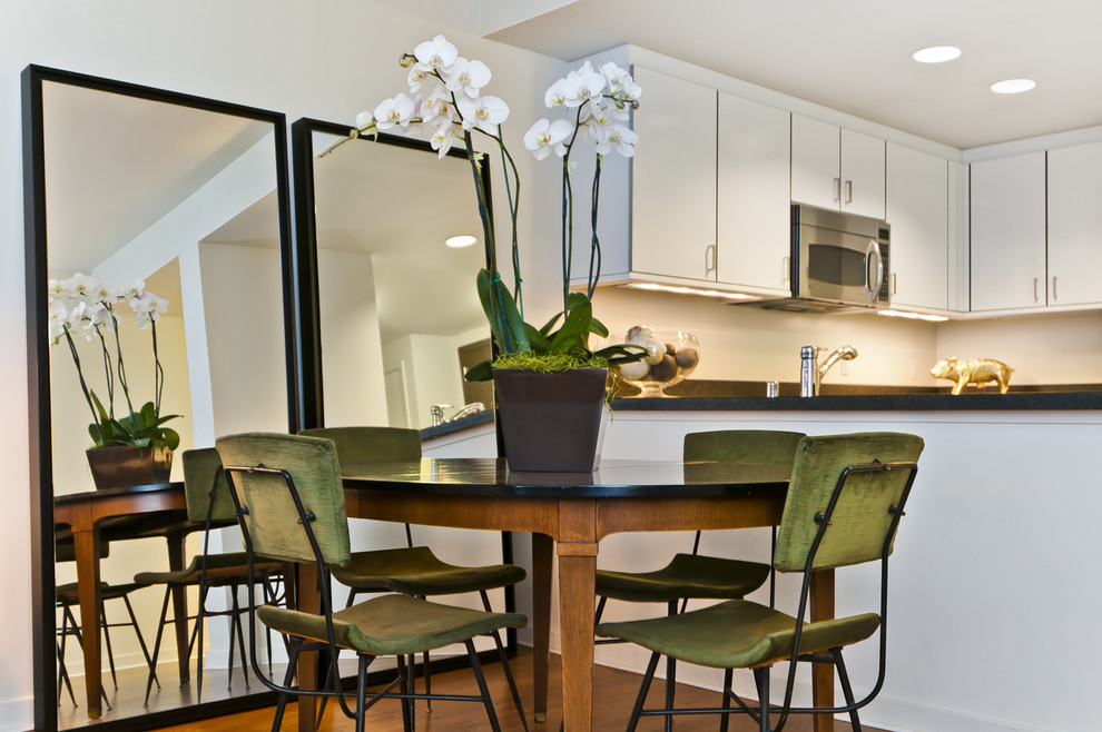 This is an example of an eclectic kitchen/dining combo in San Francisco with white walls.