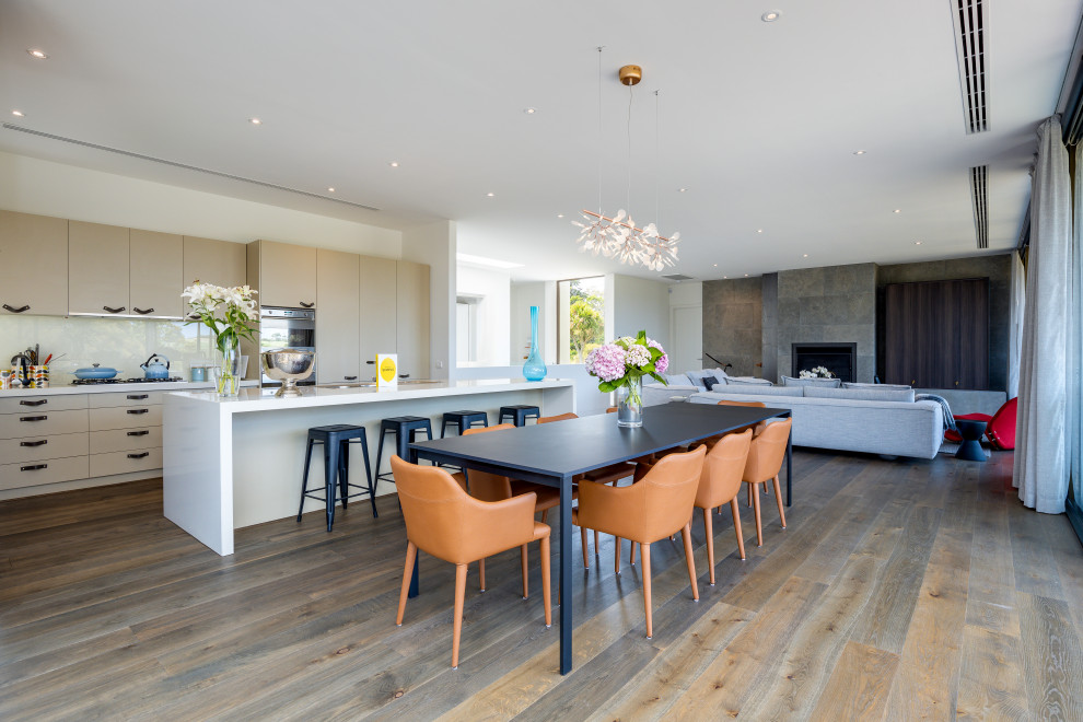 Inspiration for a contemporary open plan dining in Melbourne with white walls, dark hardwood floors and brown floor.
