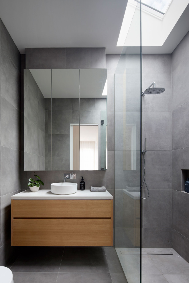 Photo of a modern ensuite bathroom in Melbourne with beige cabinets, a walk-in shower, grey tiles, porcelain tiles, grey walls, porcelain flooring, engineered stone worktops, an open shower, a wall niche and a floating vanity unit.