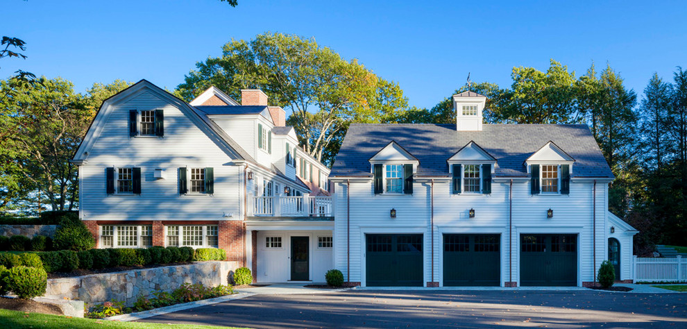 Photo of a large traditional attached three-car garage in Boston.